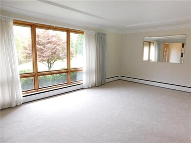 A wall of windows dapples the living room in natur