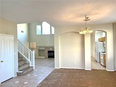 Unfurnished room featuring arched walkways, visibl
