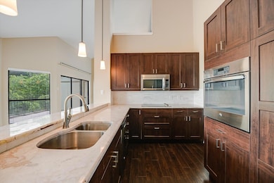 Kitchen featuring stainless steel appliances, dar
