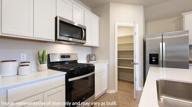 Kitchen featuring appliances with stainless steel finishes, light wood-style flooring, and white cabinets