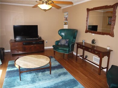 Living room has freshly painted walls, crown moldi