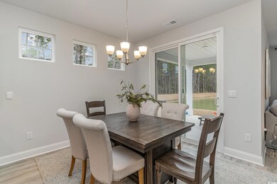 Dining area featuring an inviting chandelier and l