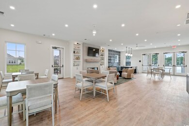 Dining room with a fireplace, light hardwood / wood-style floors, and french doors