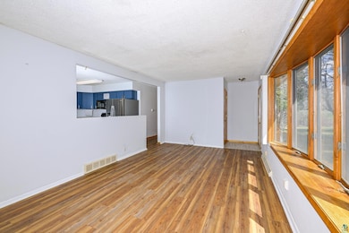 Unfurnished room with a textured ceiling, wood fin