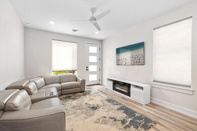 Living area with a ceiling fan, visible vents, wo