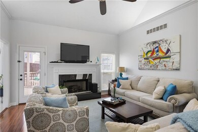 Living room featuring vaulted ceiling, visible ven
