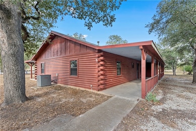View of property exterior featuring log exterior,
