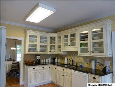 The 12'x11' kitchen has abundant white cabinetry.
