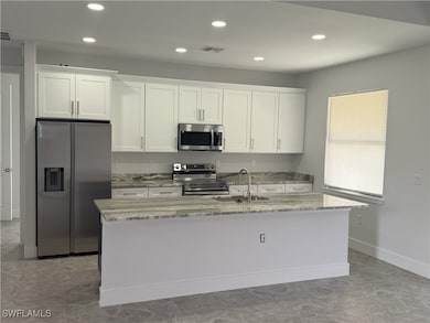 Kitchen with stainless steel appliances, a sink, a