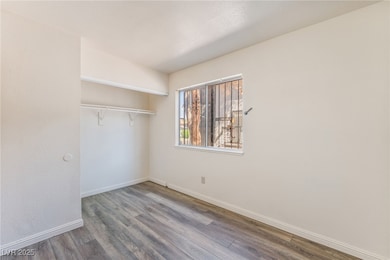 Unfurnished bedroom featuring wood finished floors and a closet