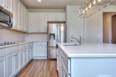 Kitchen featuring stainless steel appliances, a si