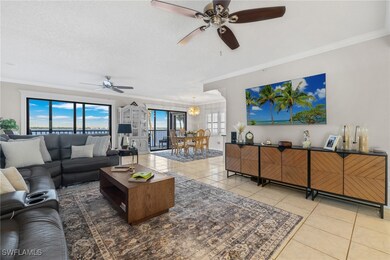 Tiled living room with crown & base molding that l