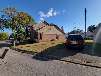 View of side of property featuring a yard