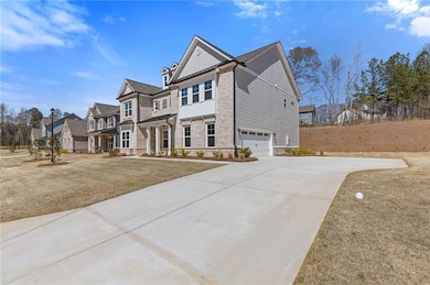 View of front of house featuring driveway, stone s