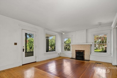 Unfurnished living room with wood-type flooring and a fireplace