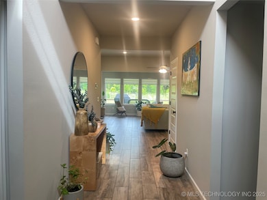 Corridor with hardwood / wood-style floors