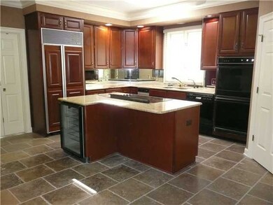 Renovated Kitchen has rich Cherry Cabinets, limest