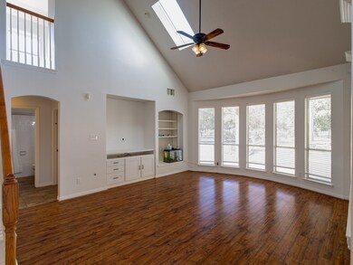 Large den with bookshelves and TV niche.
