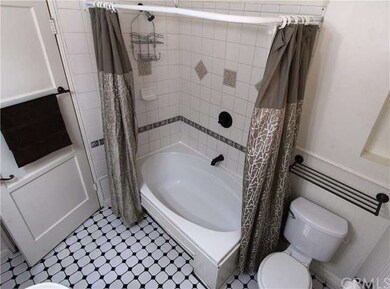 Extra LARGE Tub & side mounted Faucet makes it easy to site back & RELAX! Artwork Alcove, Craftsman Style Fixtures & period perfect TILE FLOORING.