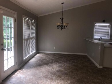 Unfurnished dining area featuring baseboards, a ch