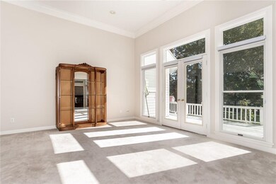 Living room with access to deck.  Notice 12' ceilings and lots of natural light.