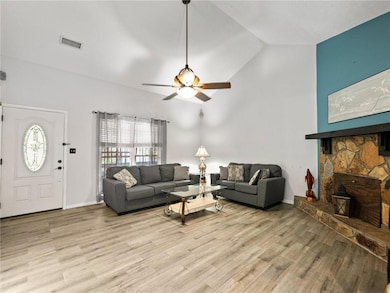 Living area with ceiling fan, light wood-style flo