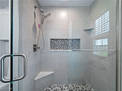 Full bath featuring a shower stall
