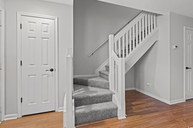 Stairs with hardwood / wood-style flooring