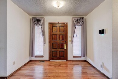 Foyer with plenty of natural light and light wood-