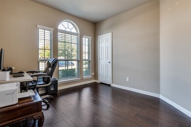 Office area with baseboards and dark wood finished floors