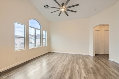 Unfurnished room featuring arched walkways, ceilin