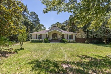 Ranch-style home with a front lawn, fence, and fre