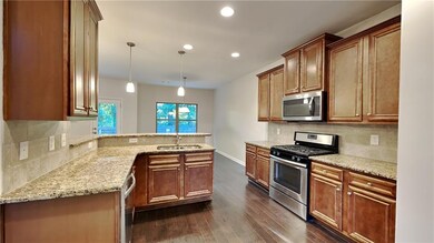 Kitchen with tasteful backsplash, stainless steel 