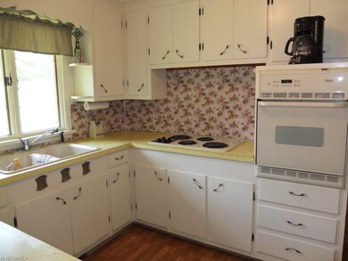 Wall oven and countertop range in the kitchen.