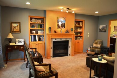Large formal living room with gas fireplace and cu