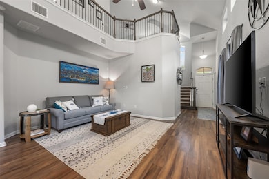 Living room with baseboards, a towering ceiling, 
