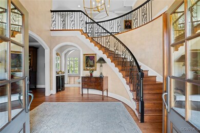 Foyer entrance with a towering ceiling, wood-type