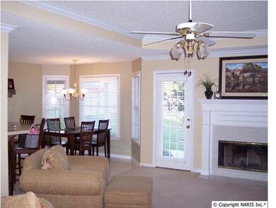 You'll love the open floor plan and the extra attention to detail with crown moldings, trey ceilings and columns. The great room features a trey ceiling and a wood burning fireplace flanked by a full length window and door.
