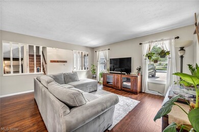 Living room with hardwood / wood-style flooring and a textured ceiling