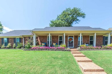 Ranch-style home featuring a front yard