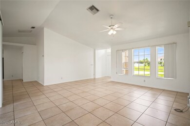 Unfurnished room featuring lofted ceiling, a ceili