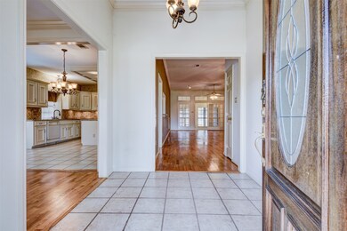 Inviting tiled entry leads to hardwood floors in the formal dining and living area.
