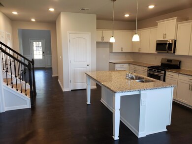 Beautiful kitchen with center island, granite counters, and SS appliances