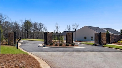 View of street with a gated entry, a gate, and curbs