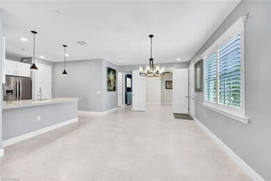 Unfurnished living room with a chandelier, light t
