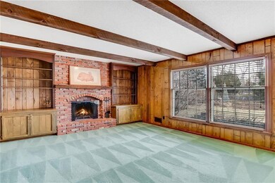 The large great room boasts a brick fireplace, dou