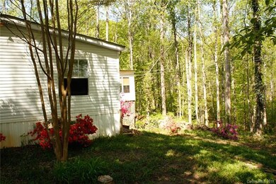 Right side of house with view of woods in the back