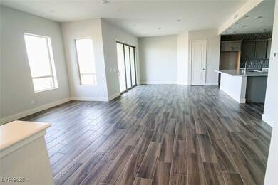 Unfurnished living room featuring dark wood-type f
