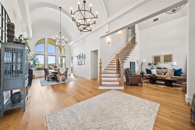 Foyer entrance featuring high vaulted ceiling, har