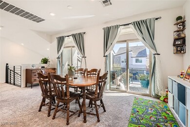 Carpeted dining room with visible vents and recess